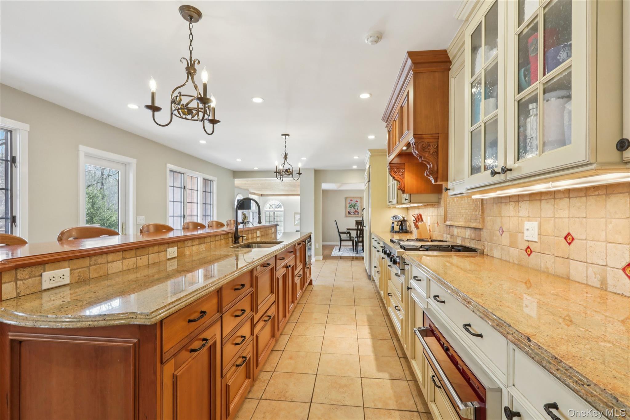 27 Cat Ridge Road North Salem, NY 10560 - Photo 18 of 45 a large kitchen with stainless steel appliances granite countertop a large counter top and a chandelier