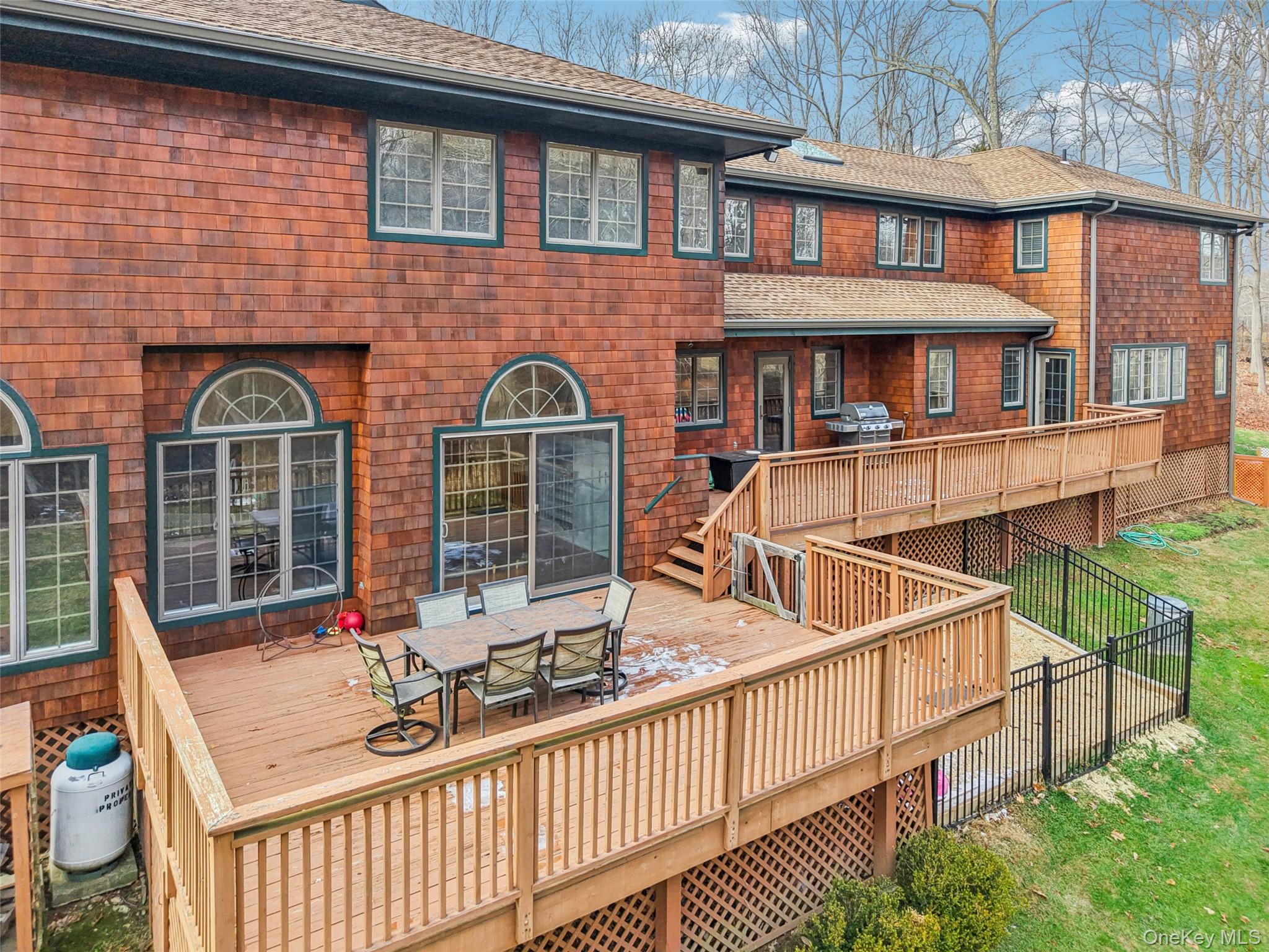 27 Cat Ridge Road North Salem, NY 10560 - Photo 40 of 46 Back of property with outdoor dining area, a wooden deck, and a shingled roof
