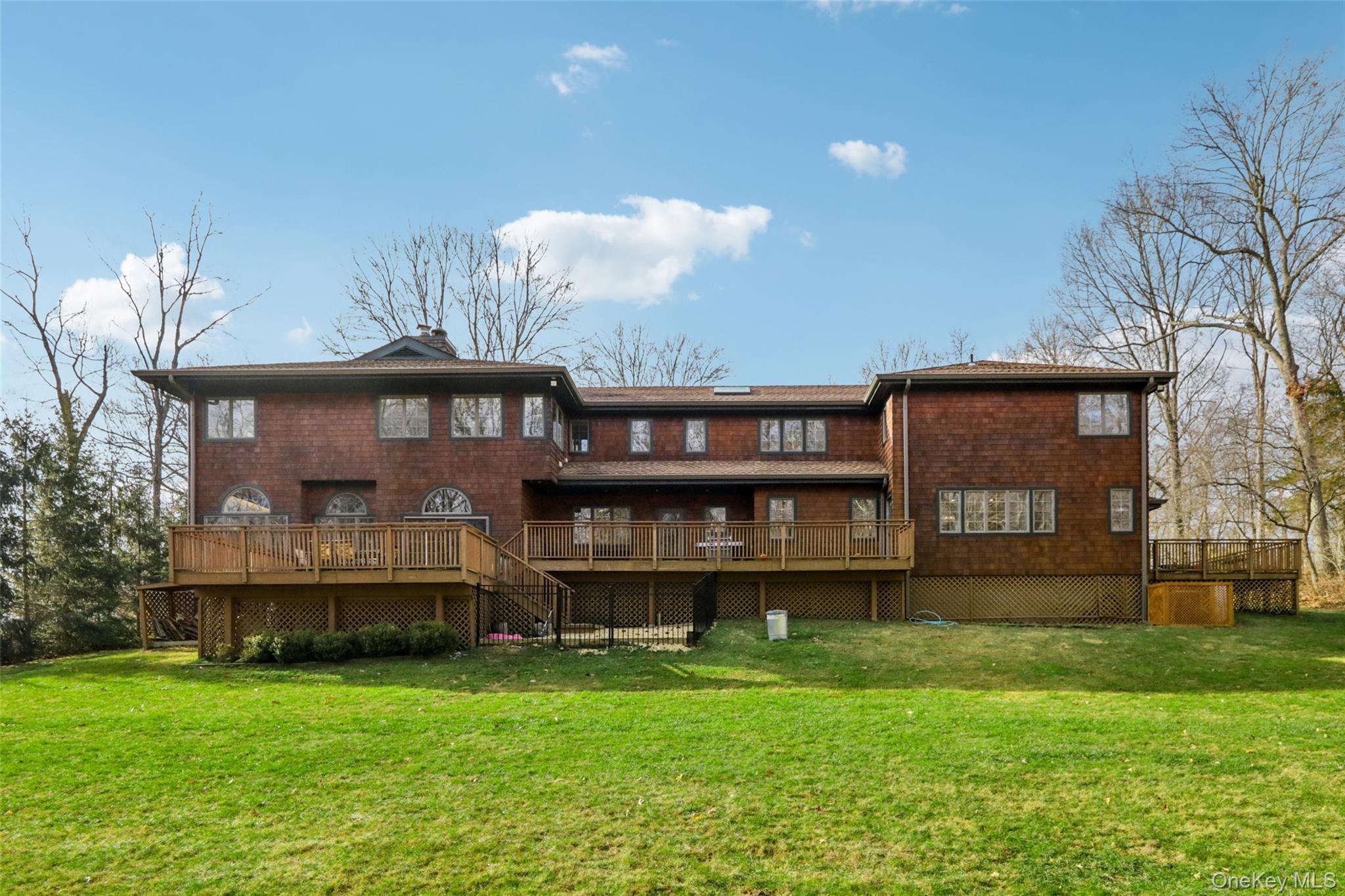 27 Cat Ridge Road North Salem, NY 10560 - Photo 42 of 46 Back of house featuring a deck, a yard, brick siding, and a chimney