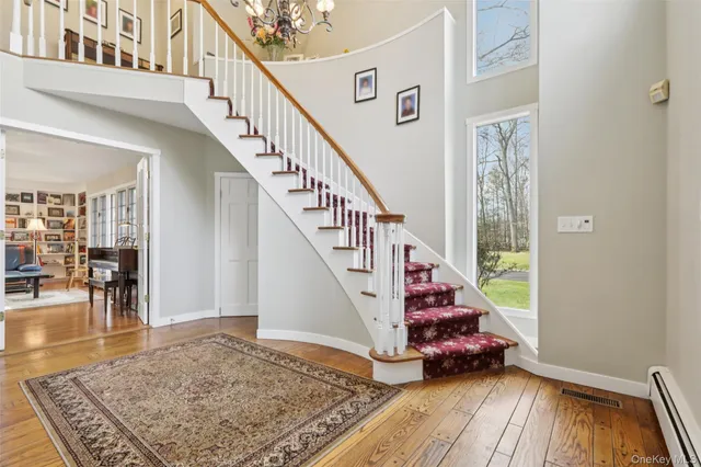 a view of entryway and hall with wooden floor