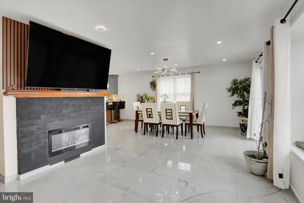 a living room with fireplace furniture and a flat screen tv