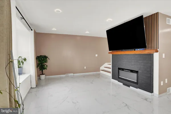 a living room with a fireplace and a flat screen tv