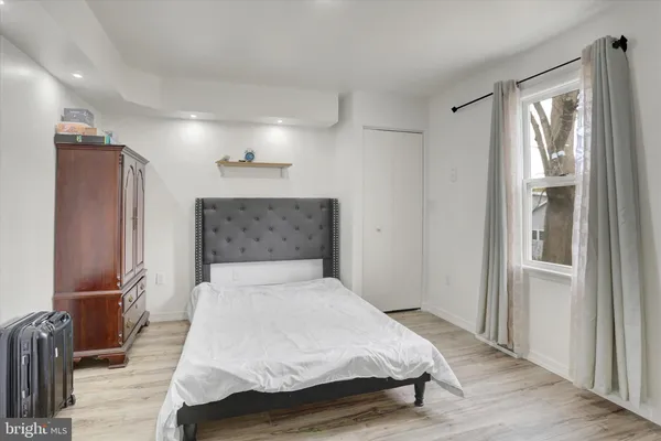 a bedroom with a bed and a mirror