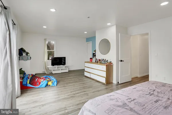 a bedroom with a bed and a dresser