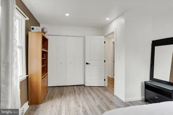 a bedroom with furniture and wooden floor