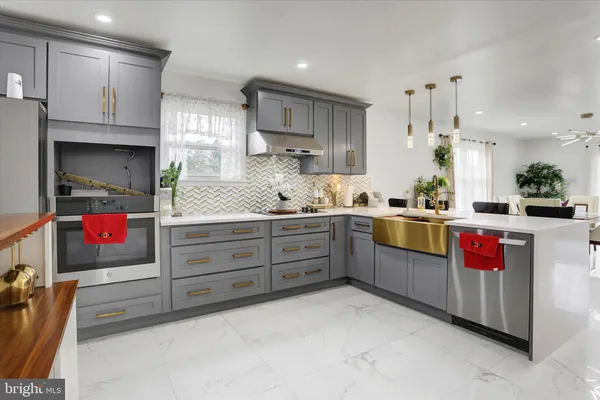 a kitchen with granite countertop a sink and cabinets