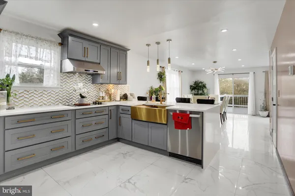 a kitchen with stainless steel appliances kitchen island granite countertop a lot of counter space and cabinets