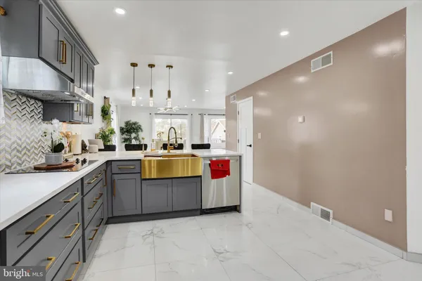 a kitchen with stainless steel appliances granite countertop a sink a stove and a refrigerator