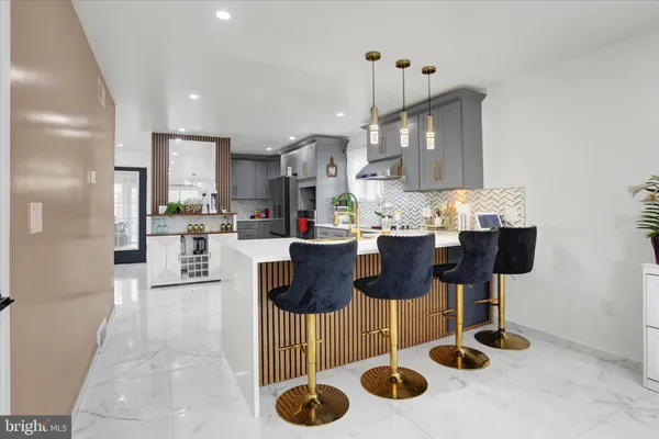 a kitchen with stainless steel appliances kitchen island granite countertop a sink and cabinets