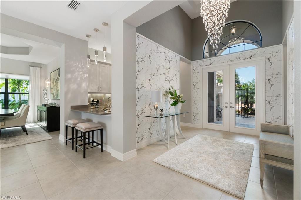 4467 Caldera Circle Naples, FL 34119 - Photo 13 of 50 a view of a hallway with dining area