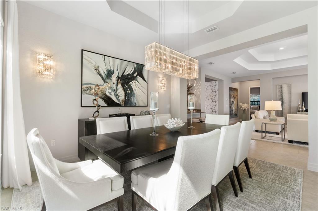 4467 Caldera Circle Naples, FL 34119 - Photo 16 of 50 a view of a dining room with furniture and a livingroom