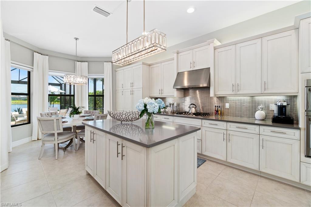 4467 Caldera Circle Naples, FL 34119 - Photo 20 of 50 a kitchen that has a lot of cabinets in it