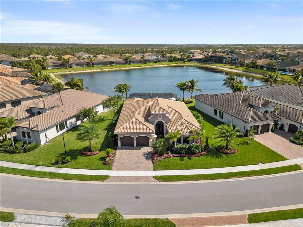 4467 Caldera Circle Naples, FL 34119 - Photo 2 of 50 an aerial view of house with yard and ocean view