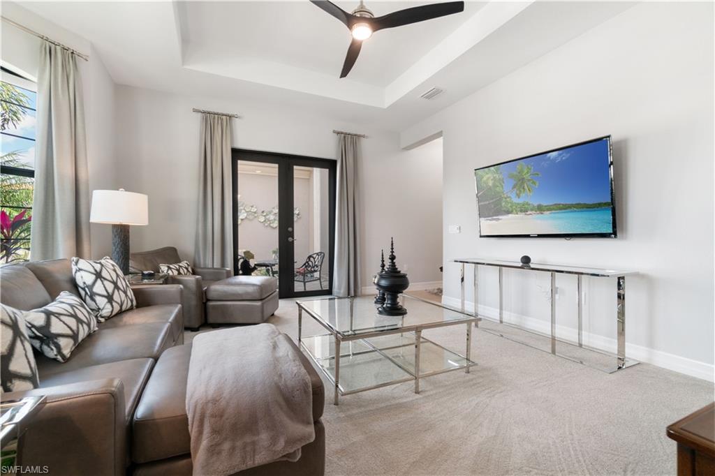 4467 Caldera Circle Naples, FL 34119 - Photo 26 of 50 a living room with furniture and a flat screen tv