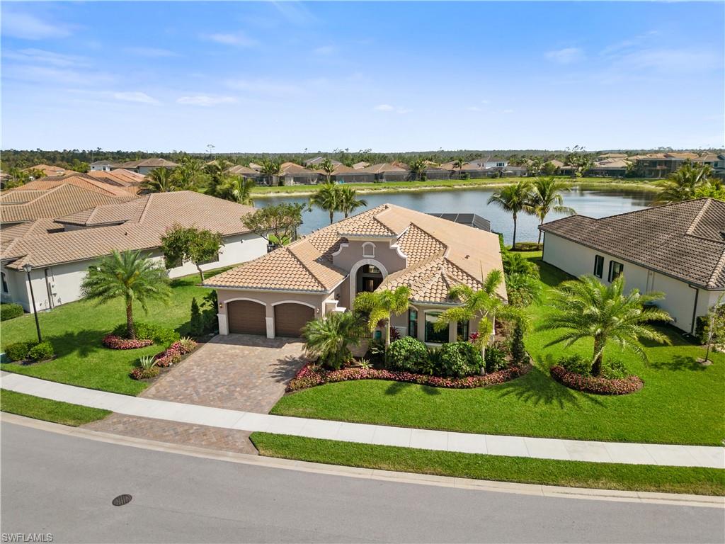 4467 Caldera Circle Naples, FL 34119 - Photo 3 of 50 an aerial view of a house with a garden