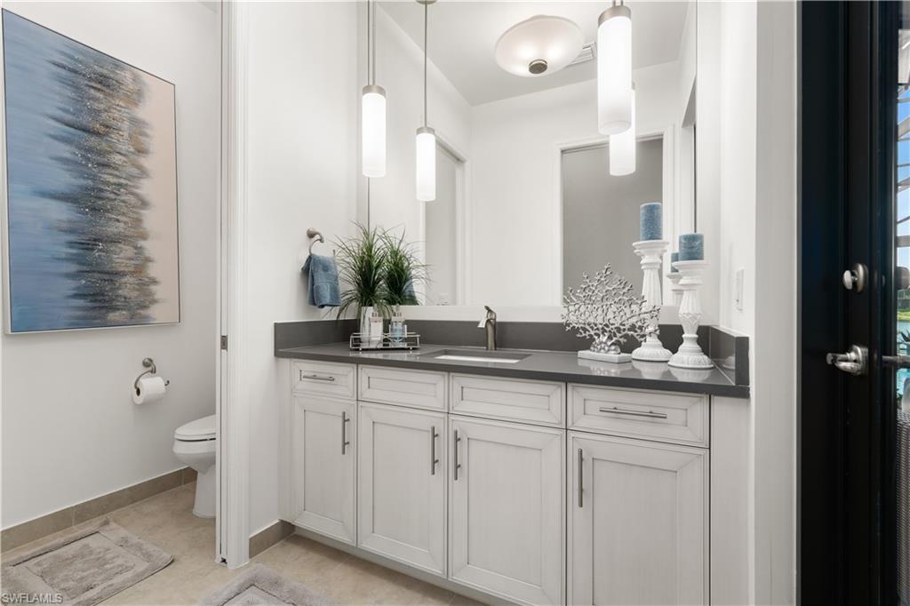 4467 Caldera Circle Naples, FL 34119 - Photo 31 of 50 a bathroom with a granite countertop sink and a toilet