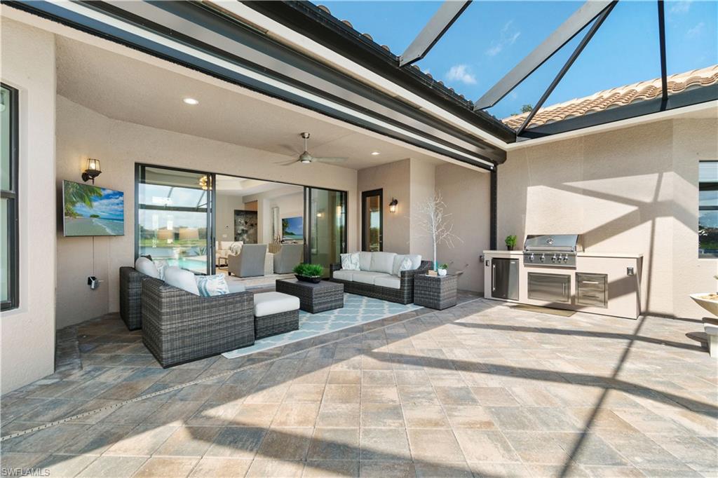 4467 Caldera Circle Naples, FL 34119 - Photo 37 of 50 a living room with furniture and a chandelier