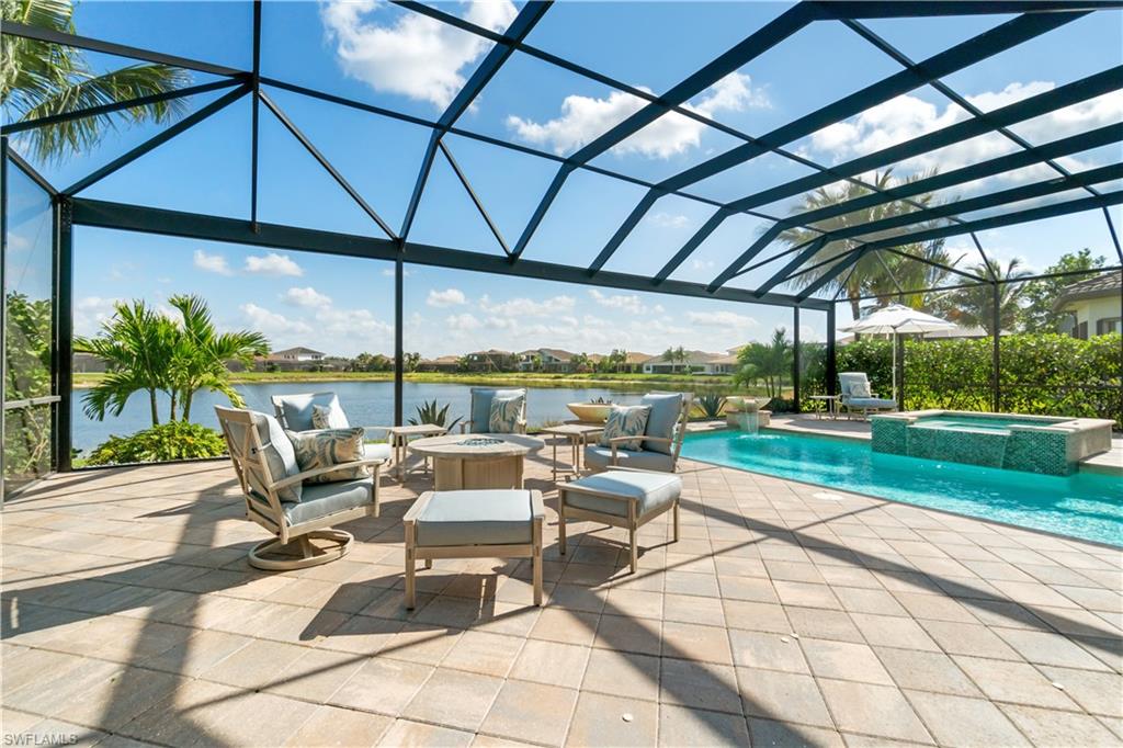 4467 Caldera Circle Naples, FL 34119 - Photo 38 of 50 a roof deck with table and chairs under an umbrella