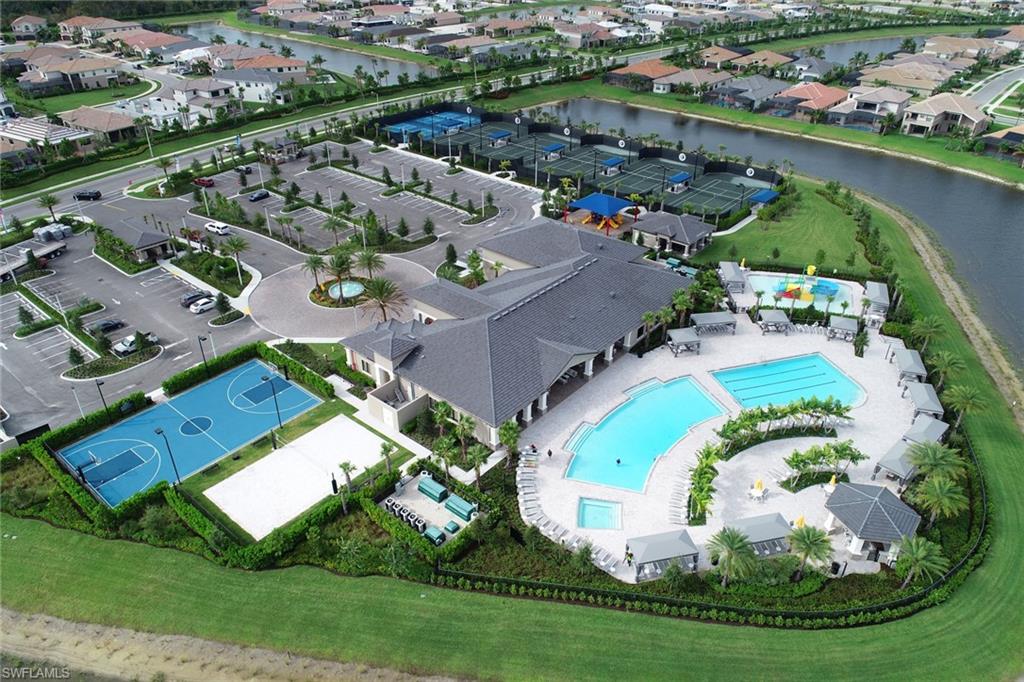 4467 Caldera Circle Naples, FL 34119 - Photo 44 of 50 an aerial view of a house with a swimming pool yard and lake view