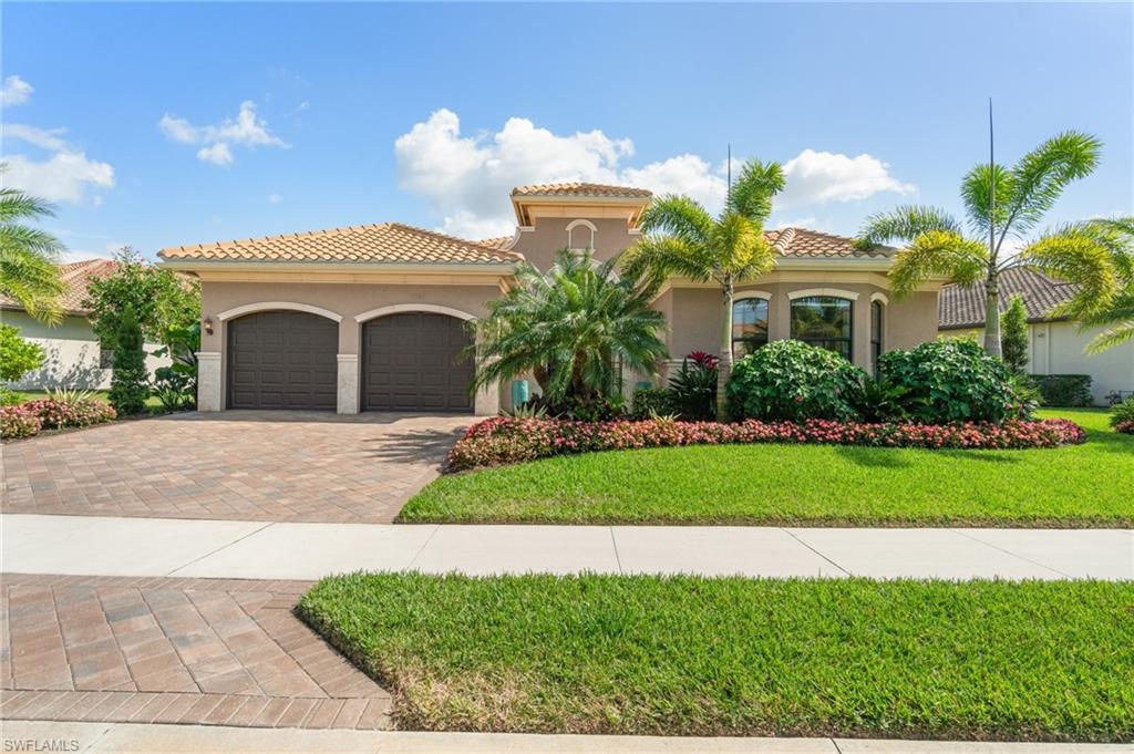 4467 Caldera Circle Naples, FL 34119 - Photo 5 of 50 a front view of a house with a garden