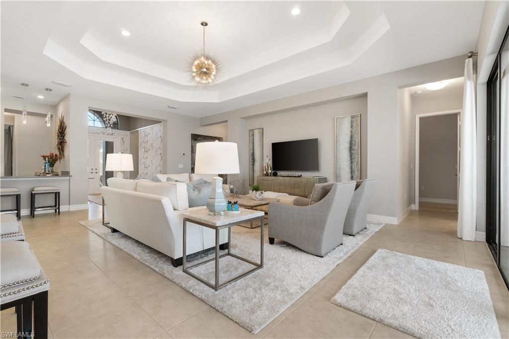 4467 Caldera Circle Naples, FL 34119 - Photo 10 of 50 a living room with furniture and a flat screen tv