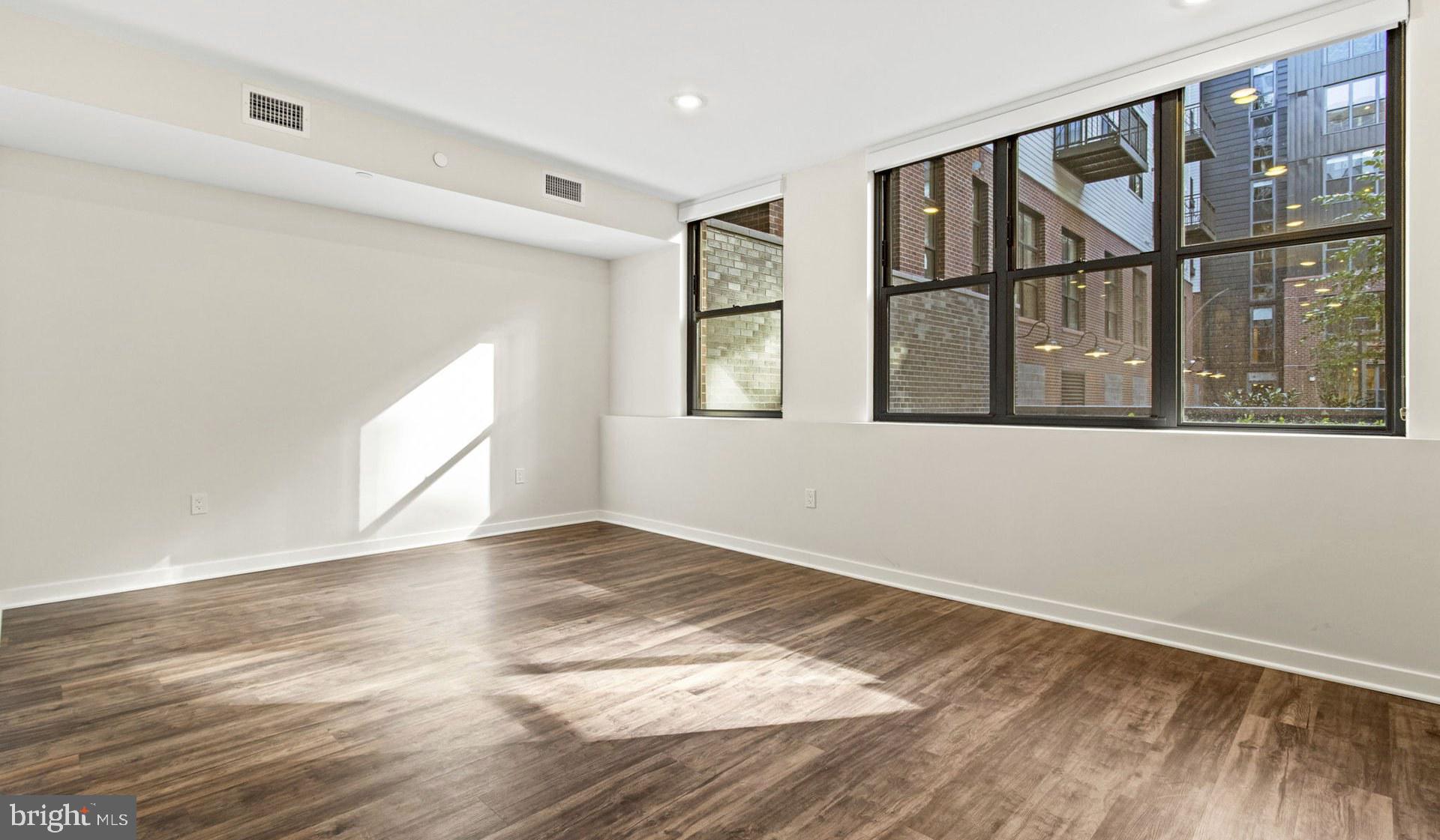 4000 Wisconsin Avenue Northwest, Unit 4K236 Washington, DC 20016 - Photo 54 of 54 a view of an empty room with wooden floor and a window