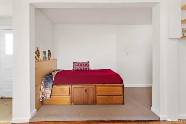 a room with a bed and a mirror