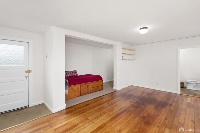 a view of a room with wooden floor and closet