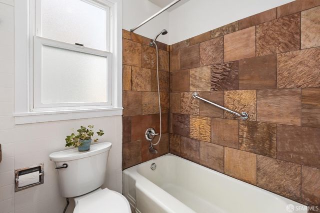 a bathroom with a toilet and a bathtub