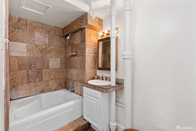 a bathroom with a bathtub and a sink