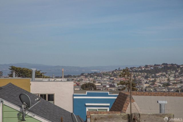a view of roof deck with a barbeque and wooden stairs