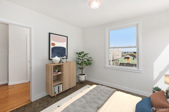 a bedroom with a bed and a painting on the wall