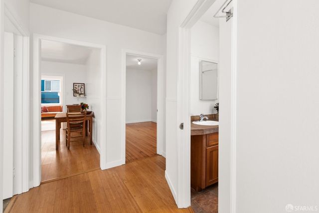 a view of living room with furniture and wooden floor