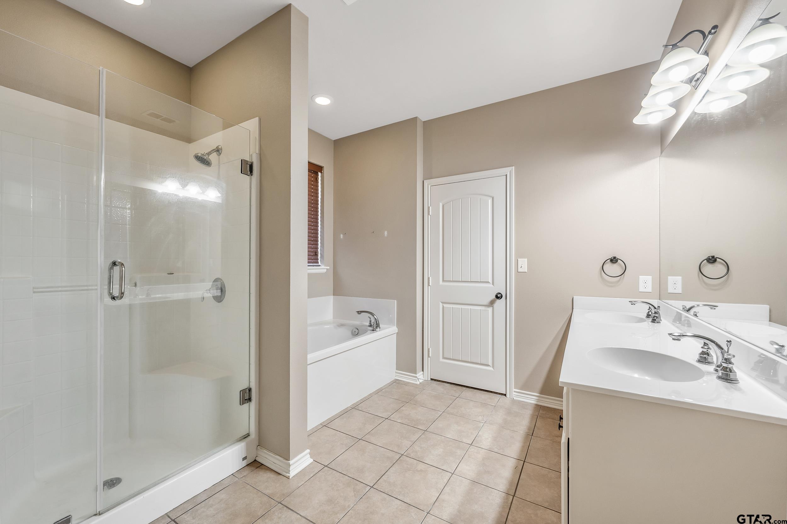 5841 Havens Trail Tyler, TX 75707 - Photo 12 of 21 a bathroom with a tub sink shower and a mirror
