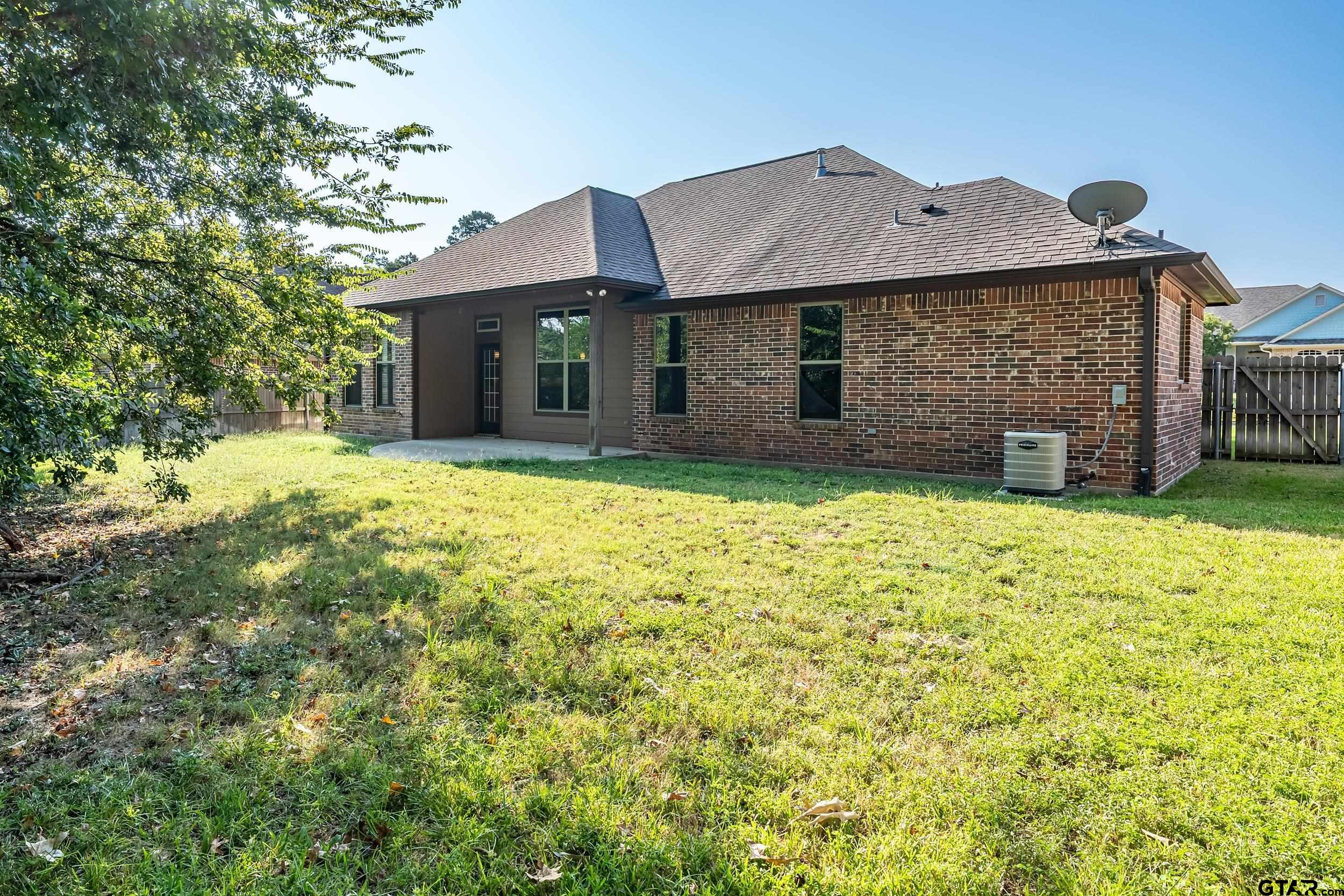 5841 Havens Trail Tyler, TX 75707 - Photo 20 of 21 a view of a house with a yard and garage