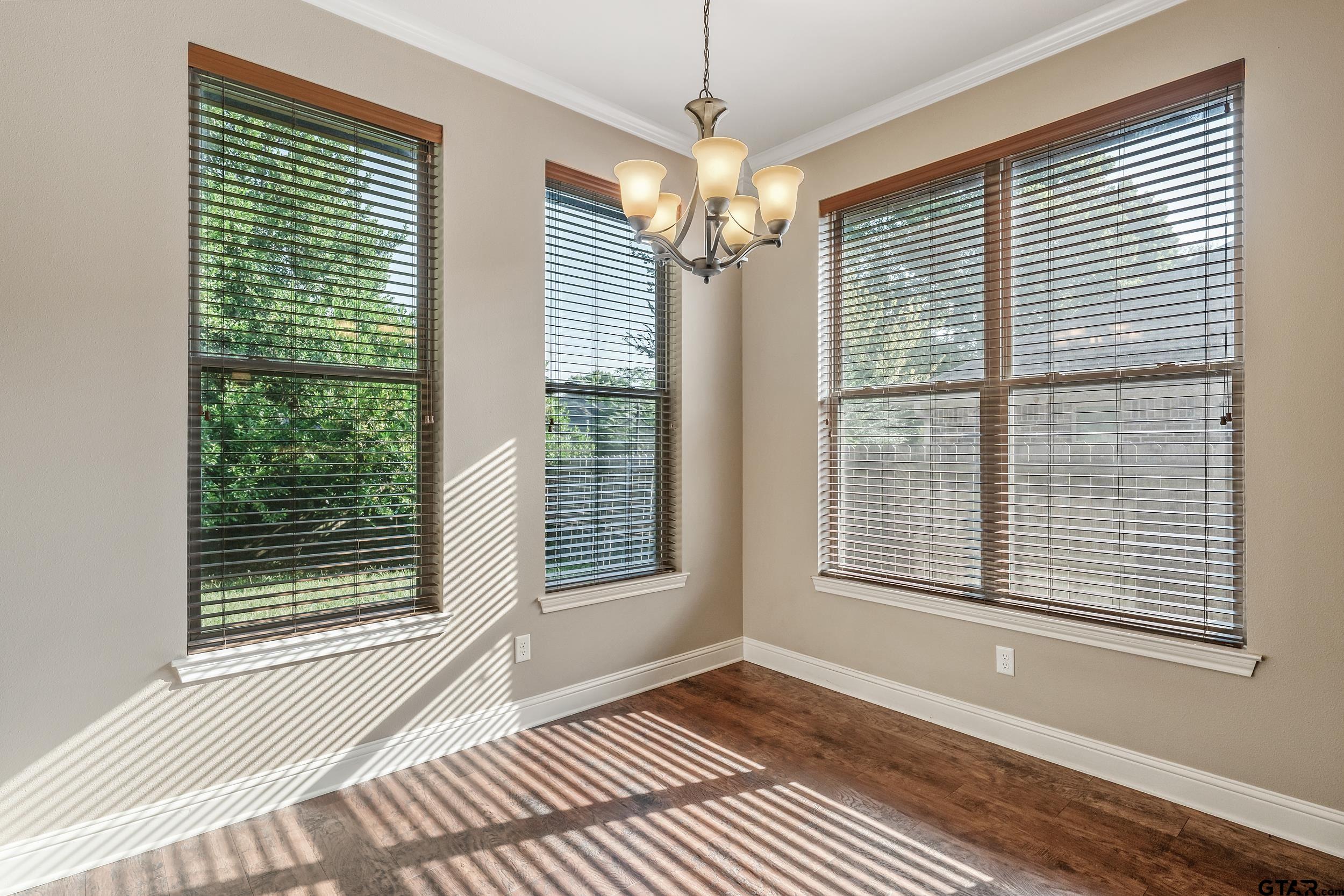 5841 Havens Trail Tyler, TX 75707 - Photo 8 of 21 a view of an empty room with a window and wooden floor