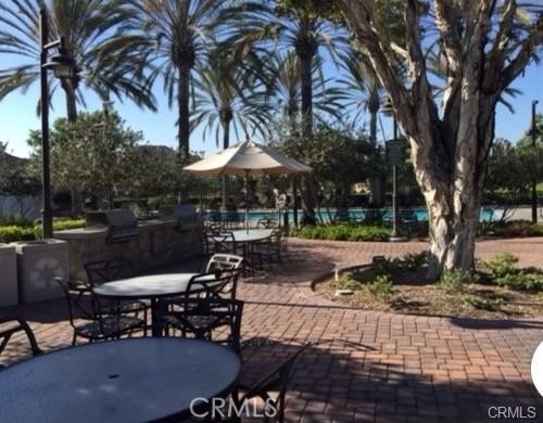 1415 Abelia Irvine, CA 92606 - Photo 12 of 13 a view of a patio with a table and chairs under an umbrella