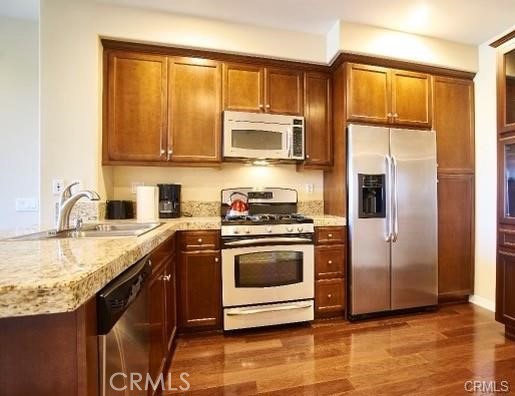 1415 Abelia Irvine, CA 92606 - Photo 2 of 13 a kitchen with stainless steel appliances granite countertop a stove a sink and a refrigerator