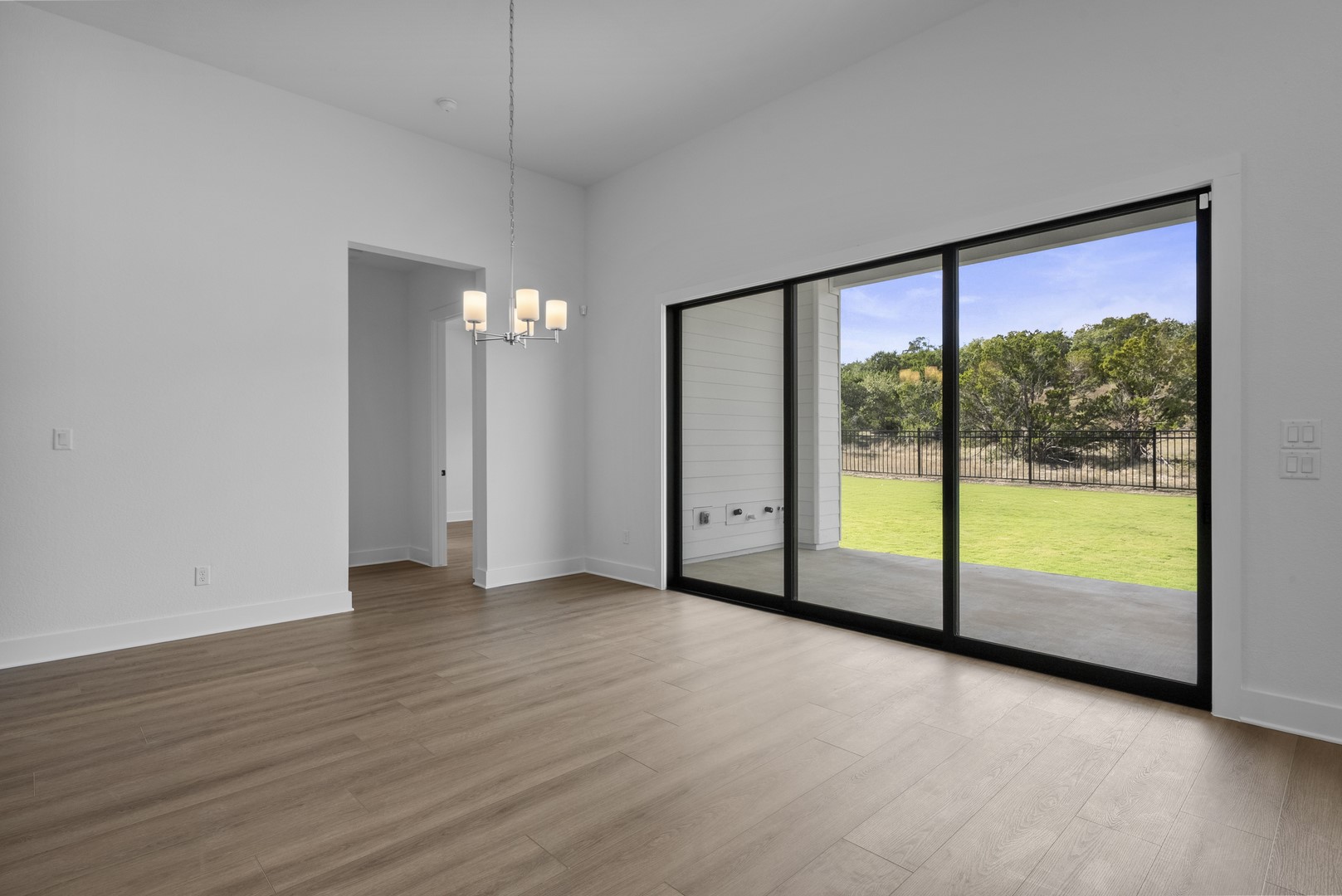 263 Iron Willow Loop Dripping Springs, TX 78620 - Photo 23 of 26 a view of an empty room with wooden floor and a window