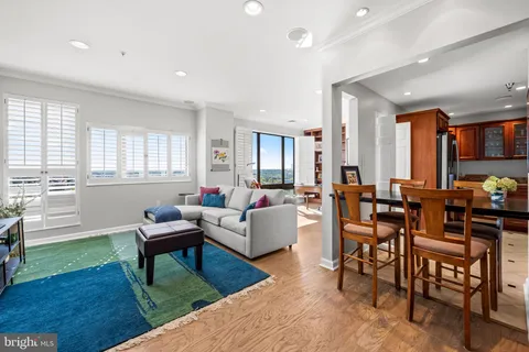 a living room with furniture a dining table and a piano next to a window