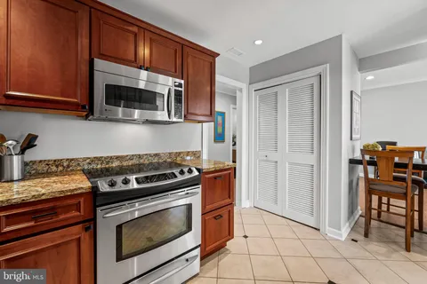 a kitchen with granite countertop a stove and a microwave oven