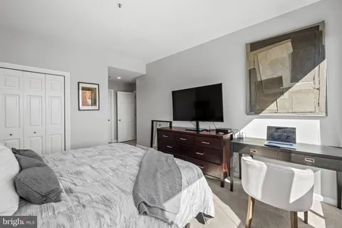 a bedroom with a bed and a flat screen tv