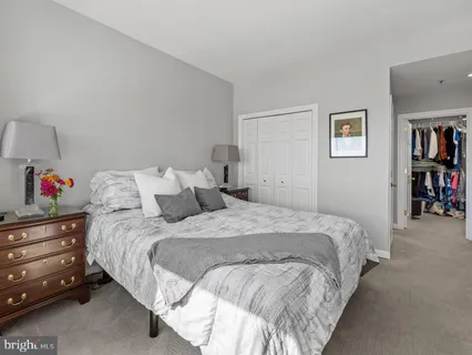 a bed room with a bed and a book shelf