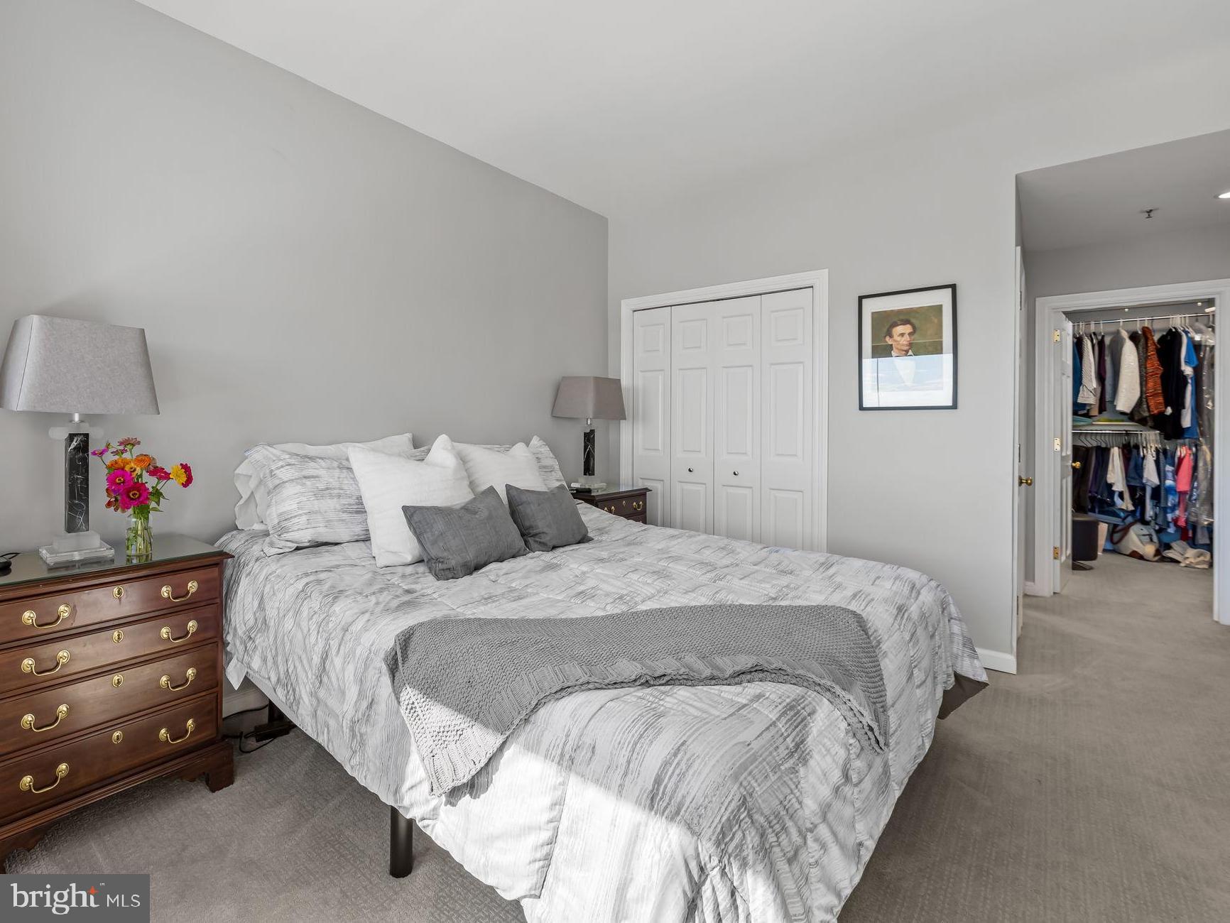 10 East Lee Street, Unit 1103 Baltimore, MD 21202 - Photo 21 of 42 a bed room with a bed and a book shelf