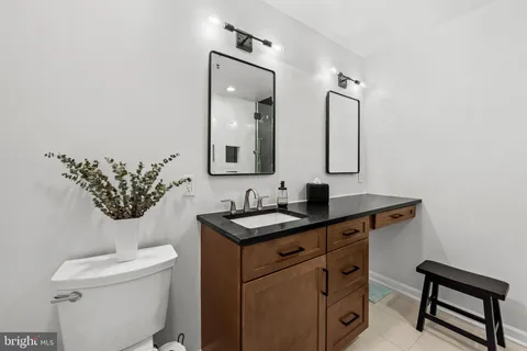 a bathroom with a toilet a sink and mirror