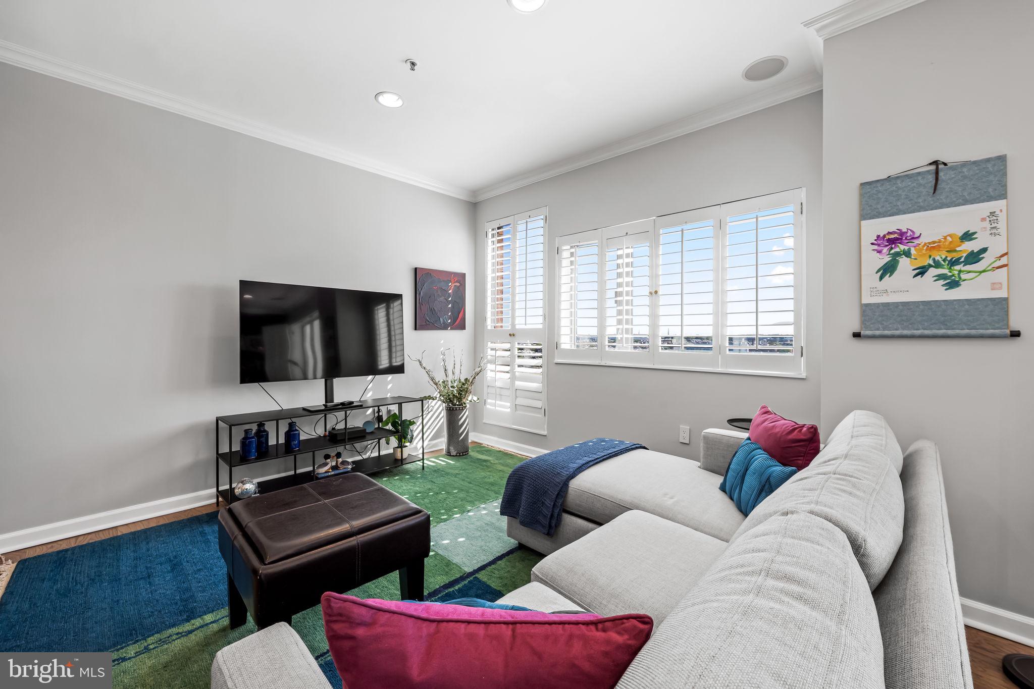 10 East Lee Street, Unit 1103 Baltimore, MD 21202 - Photo 7 of 42 a living room with furniture workspace and a window