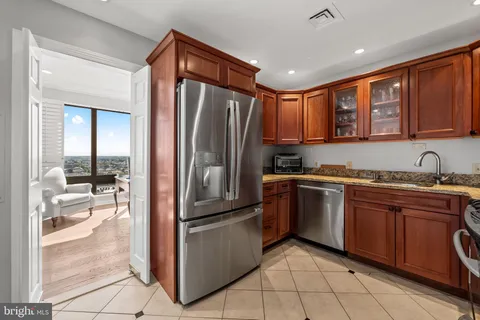 a kitchen with stainless steel appliances granite countertop a refrigerator and a sink