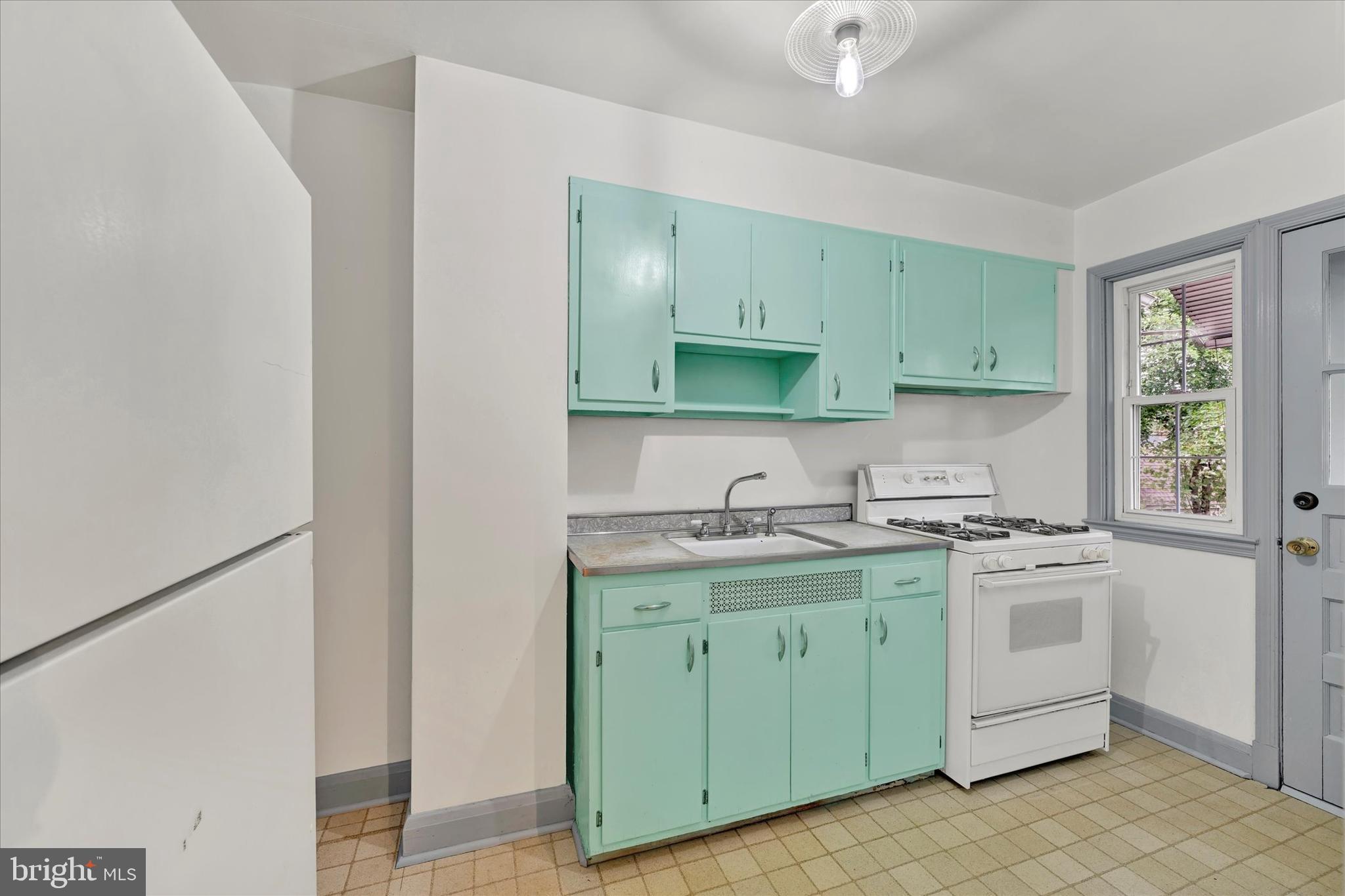 8445 Water Oak Road Baltimore, MD 21234 - Photo 8 of 17 a kitchen with a sink stove and cabinets