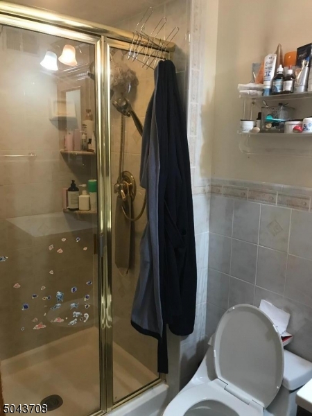 82 Cloverdale Road, Unit 1 Clifton, NJ 07013 - Photo 11 of 12 a bathroom with a toilet and a shower