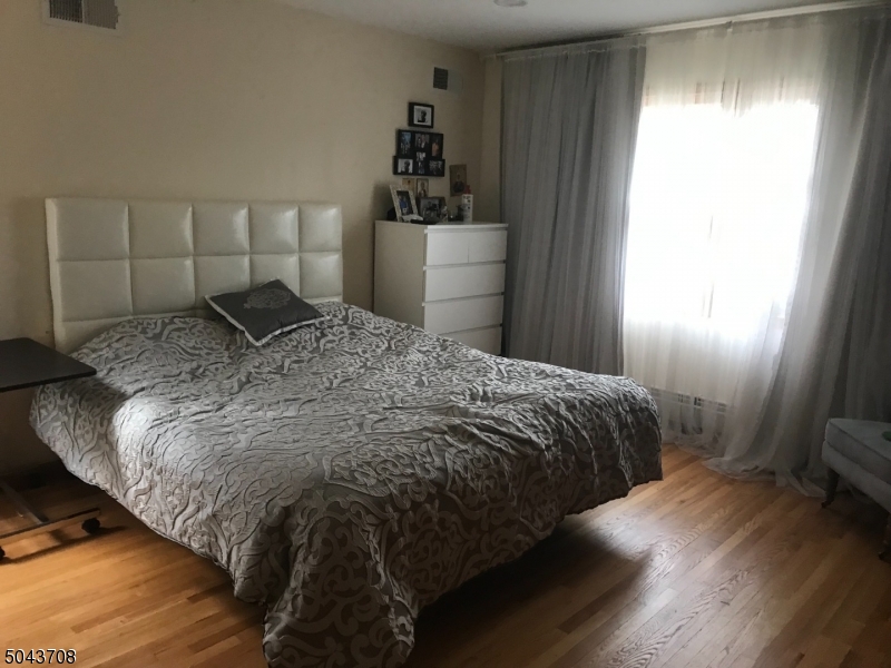 82 Cloverdale Road, Unit 1 Clifton, NJ 07013 - Photo 12 of 12 a bedroom with a bed and a window